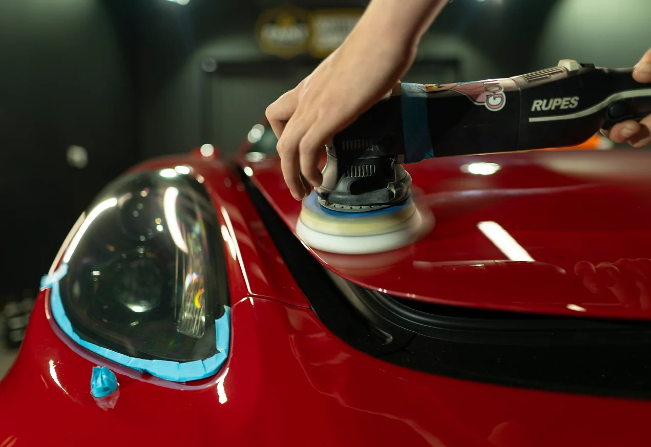 brushing a red car hood